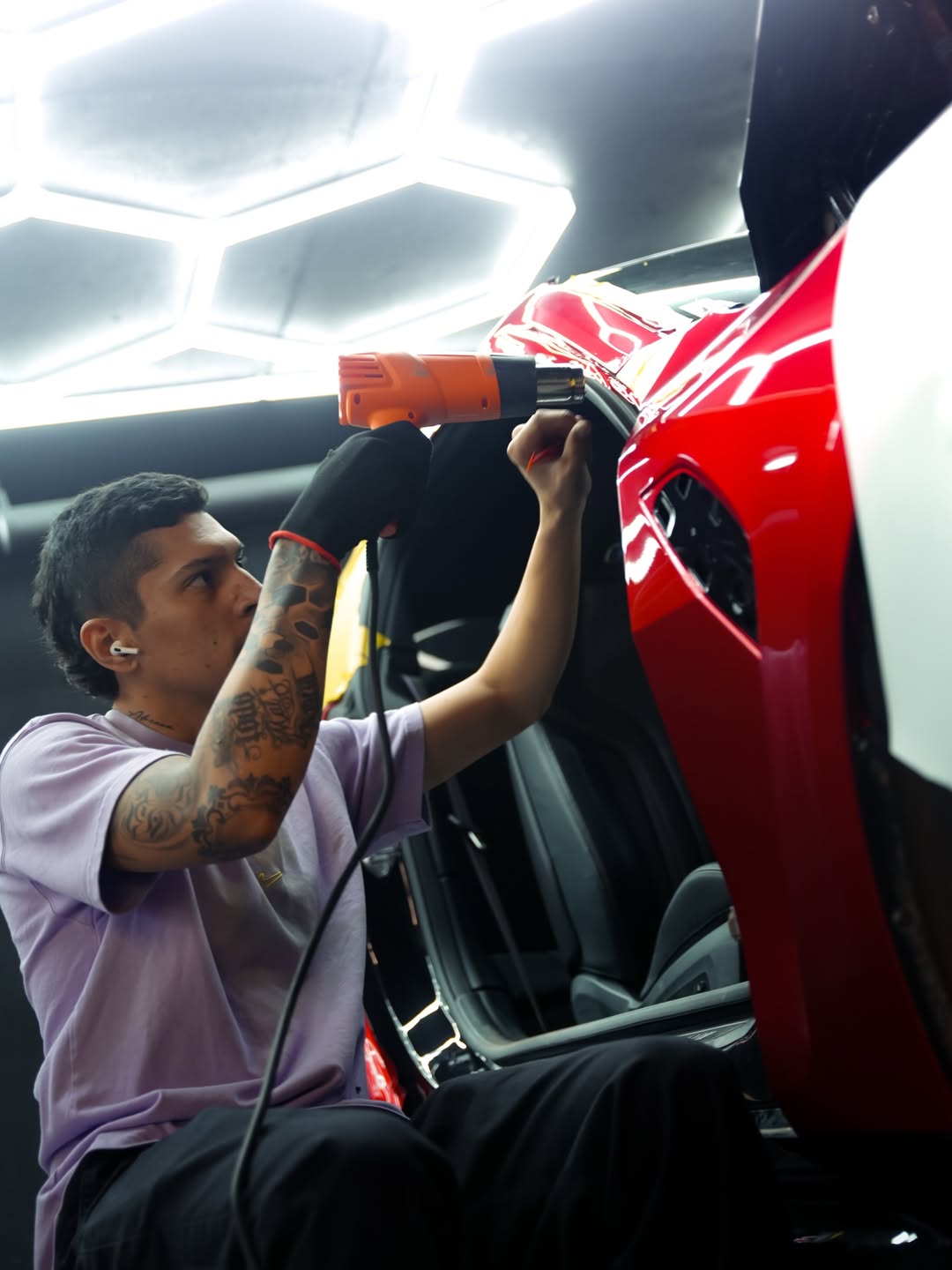 Porsche 911 GT3 RS in satin black under the EST Wrap hex-light installation bay