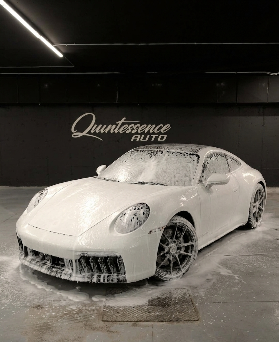 Porsche 911 foam bath under the Quintessence Auto wall